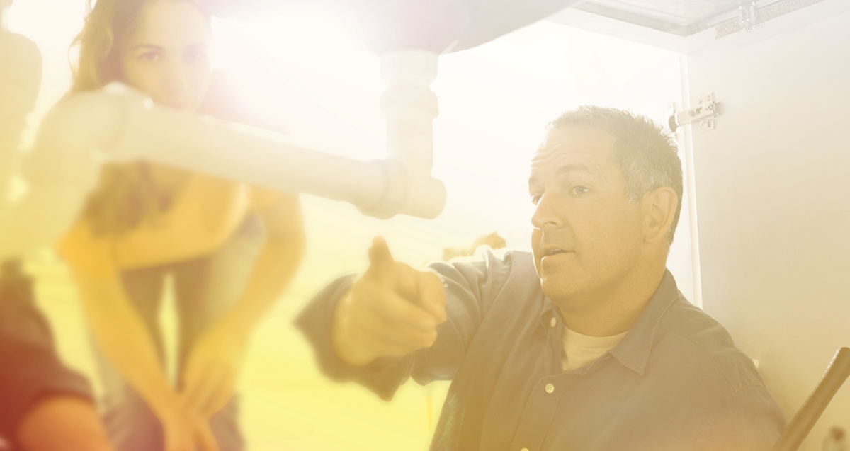 Plumber fixing pipe